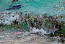 نفايات بلاستيكية وقمامة أخرى تجرفها موجة إلى شاطئ في خليج تايلند (غيتي)